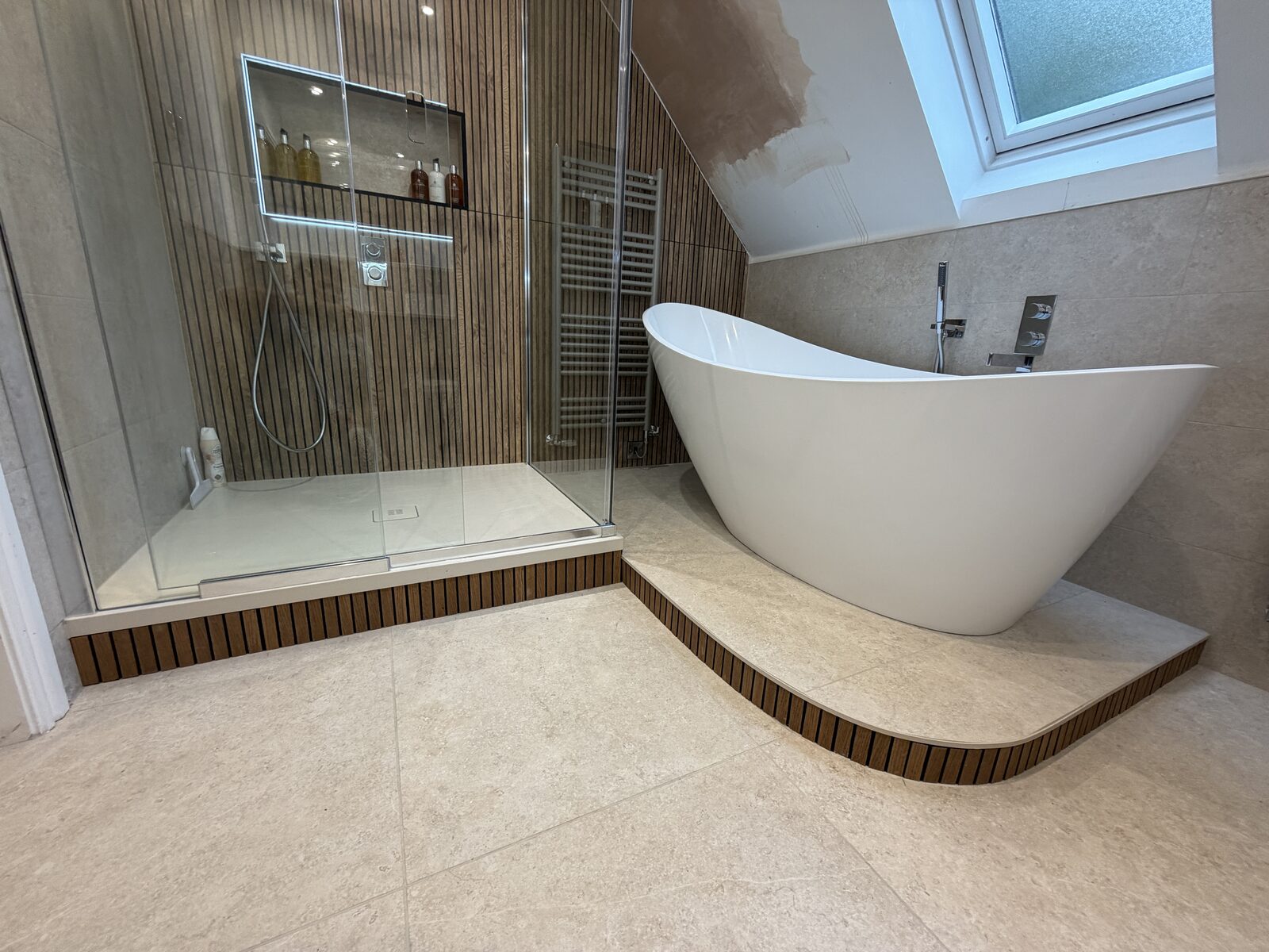 Loft bathroom with freestanding bath and wood slat wall panelling, Harrogate