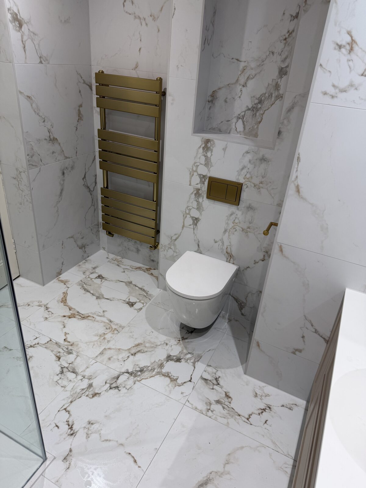 WC nook with brass heated towel rail